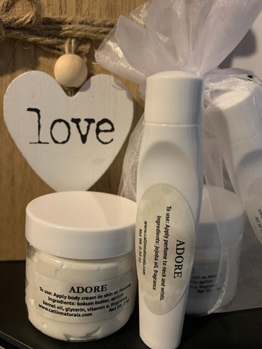small white clear jar of  body cream with white lid,  small white roll on perfume bottle 