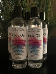 several clear bottles of body oil with black top