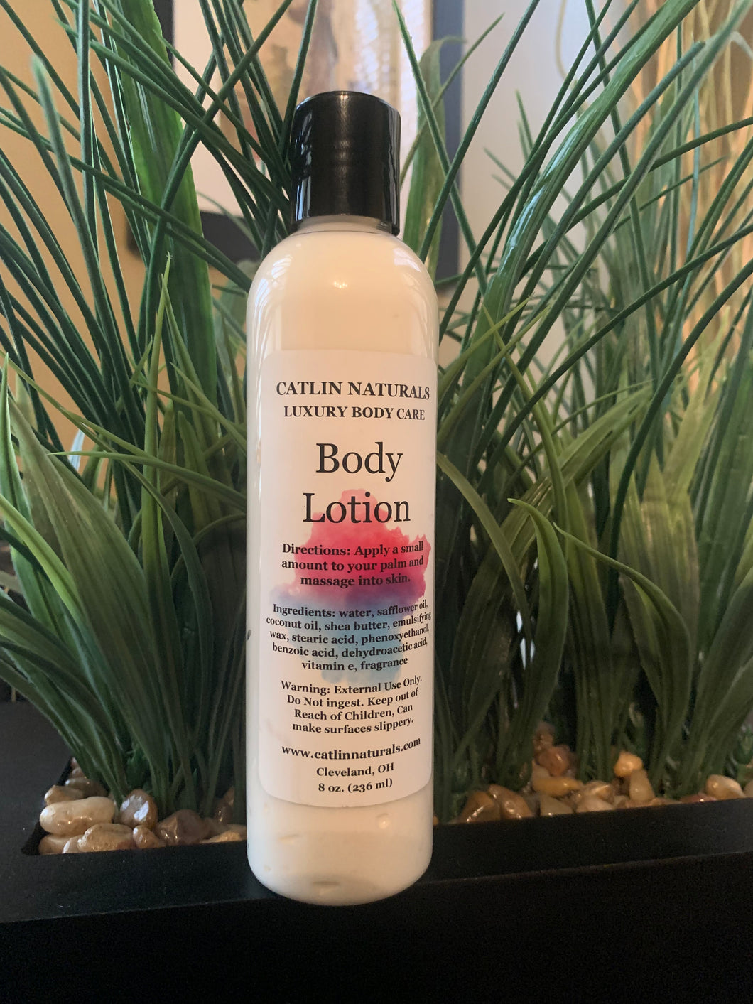 large clear bottle of lotion with black top